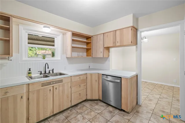 a kitchen with stainless steel appliances a sink a stove and a refrigerator