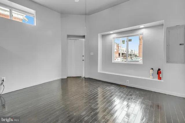 a view of an empty room and wooden floor