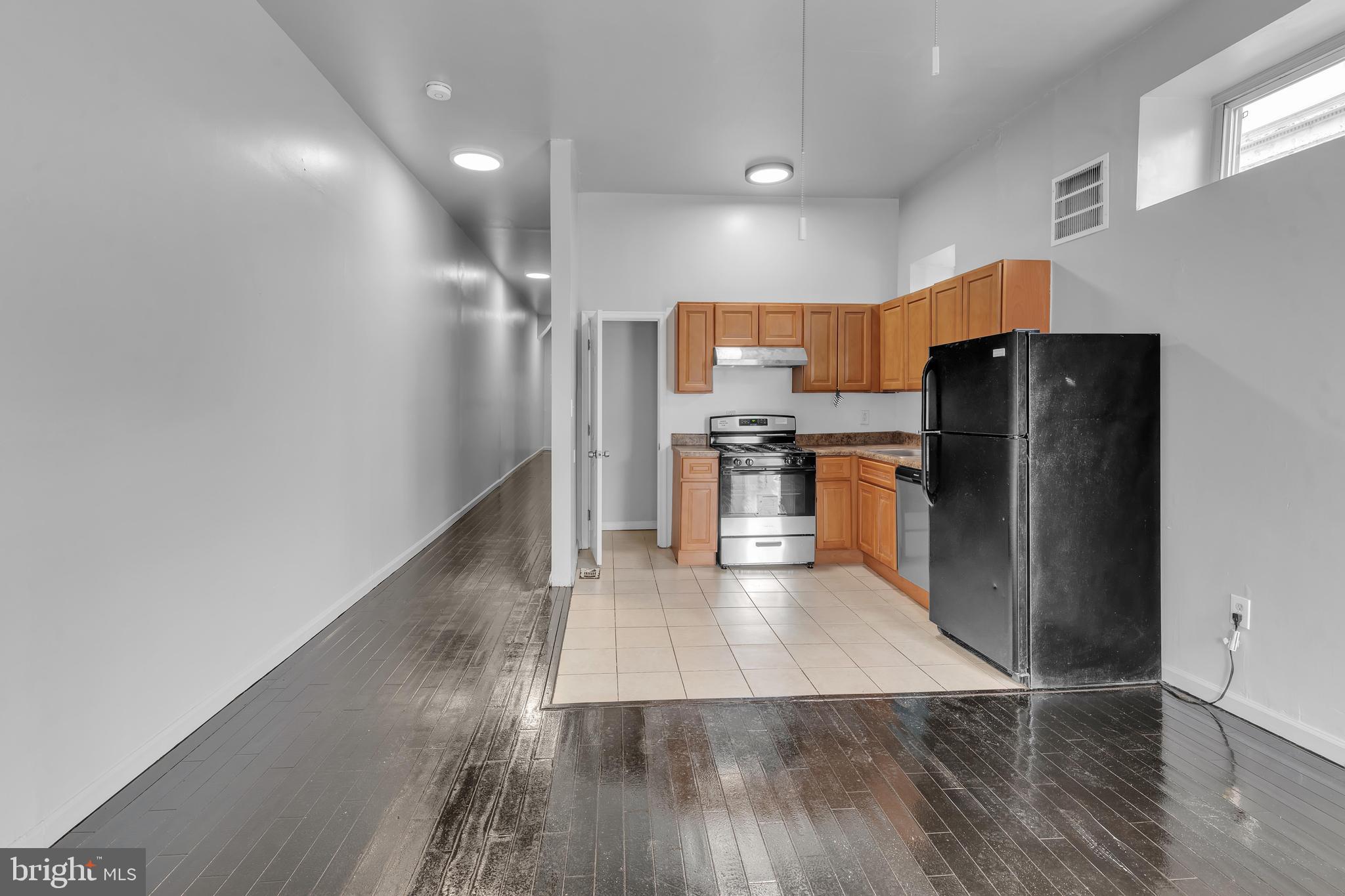 434 South 56th Street, Unit A Philadelphia, PA 19143 - Photo 14 of 19 a kitchen with stainless steel appliances a refrigerator and a stove top oven