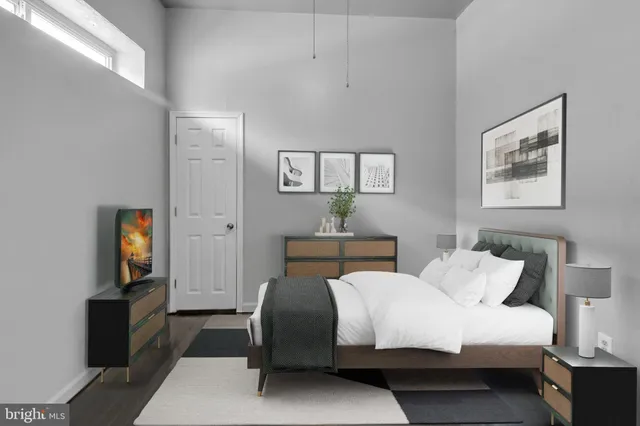 a bedroom with a bed and a tv