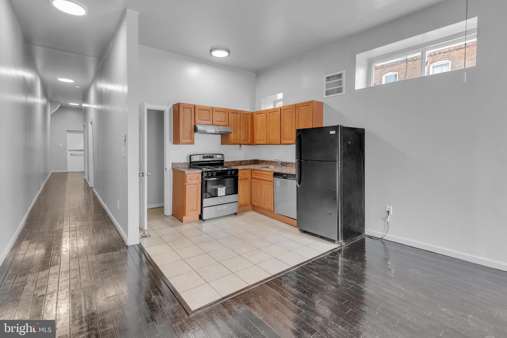434 South 56th Street, Unit A Philadelphia, PA 19143 - Photo 10 of 19 a kitchen with stainless steel appliances granite countertop a refrigerator a stove and a sink