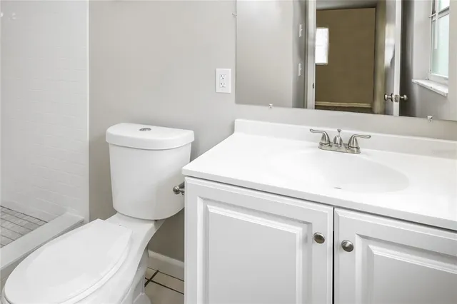 a white toilet sitting next to a bathroom sink