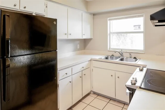 a kitchen with a refrigerator and a sink