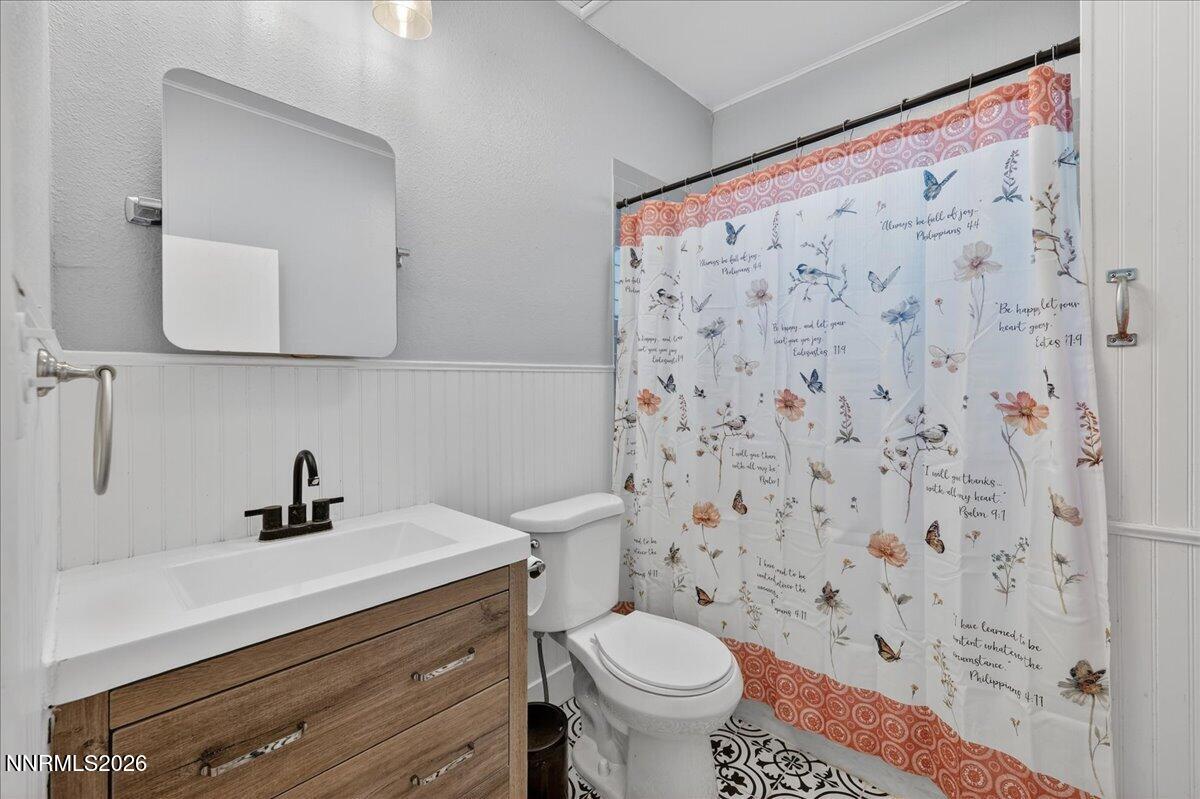 317 South Center Street Yerington, NV 89447 - Photo 15 of 27 a bathroom with a sink toilet and a mirror