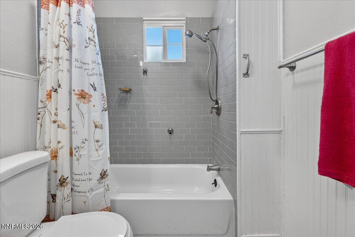 317 South Center Street Yerington, NV 89447 - Photo 16 of 27 a bathroom with a toilet and a bathtub
