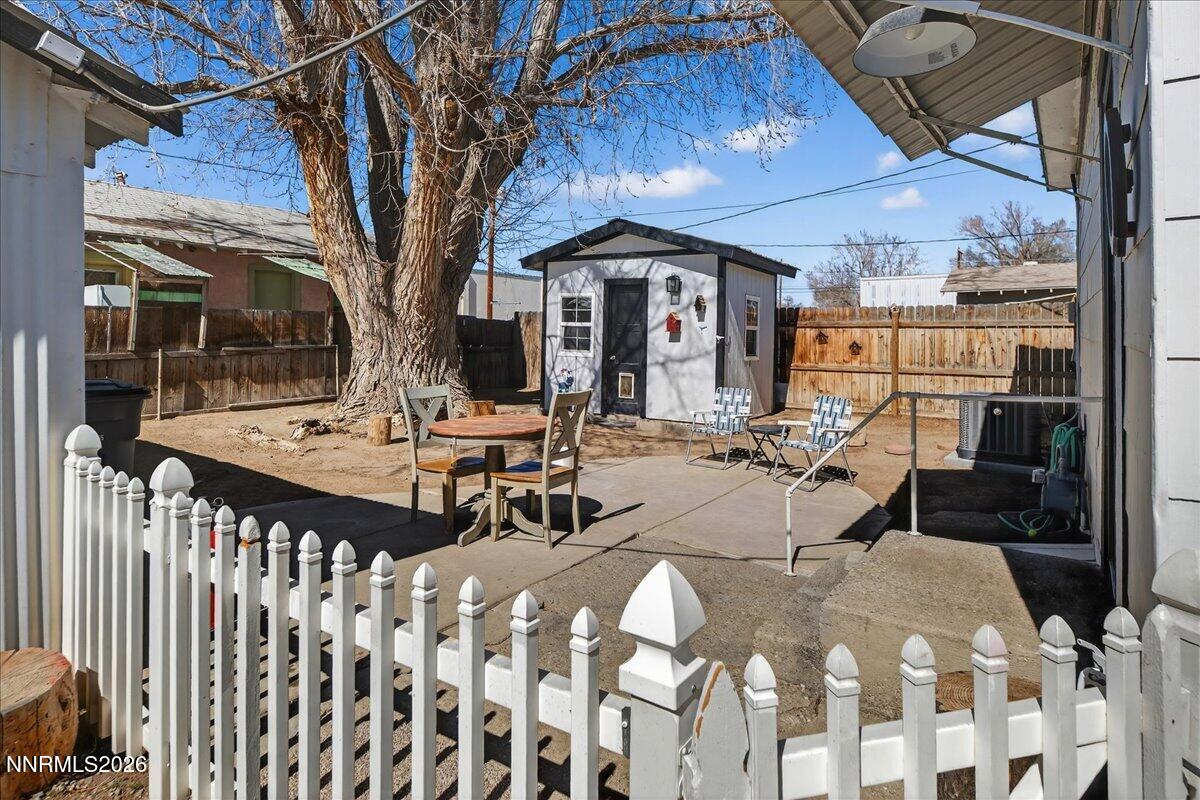 317 South Center Street Yerington, NV 89447 - Photo 19 of 27 a view of a patio with table and chairs with wooden floor and fence