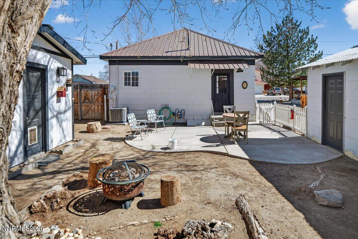 317 South Center Street Yerington, NV 89447 - Photo 20 of 27 a view of a patio with table and chairs potted plants and wooden fence