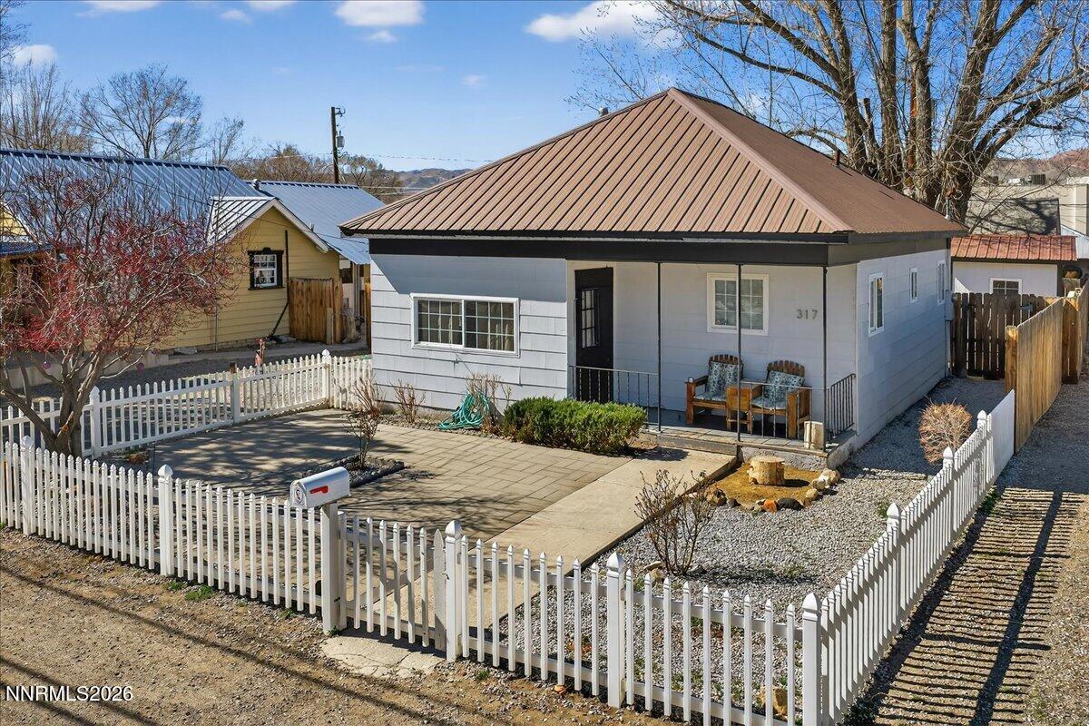 317 South Center Street Yerington, NV 89447 - Photo 3 of 27 a front view of house with yard outdoor seating and barbeque oven
