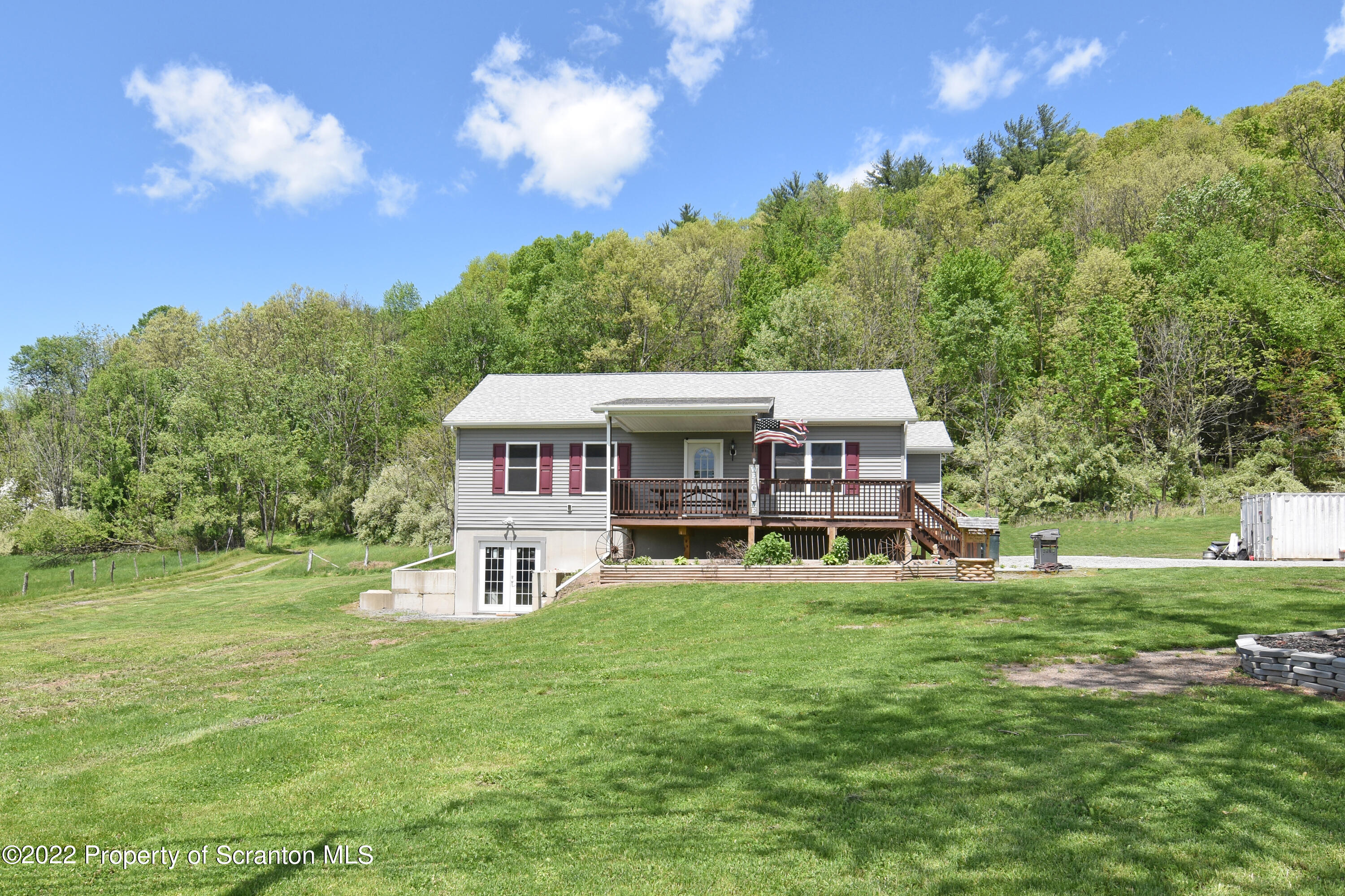 209 Oliver Road Meshoppen, PA 18630 - Photo 1 of 24 a view of a big house with a big yard and large trees