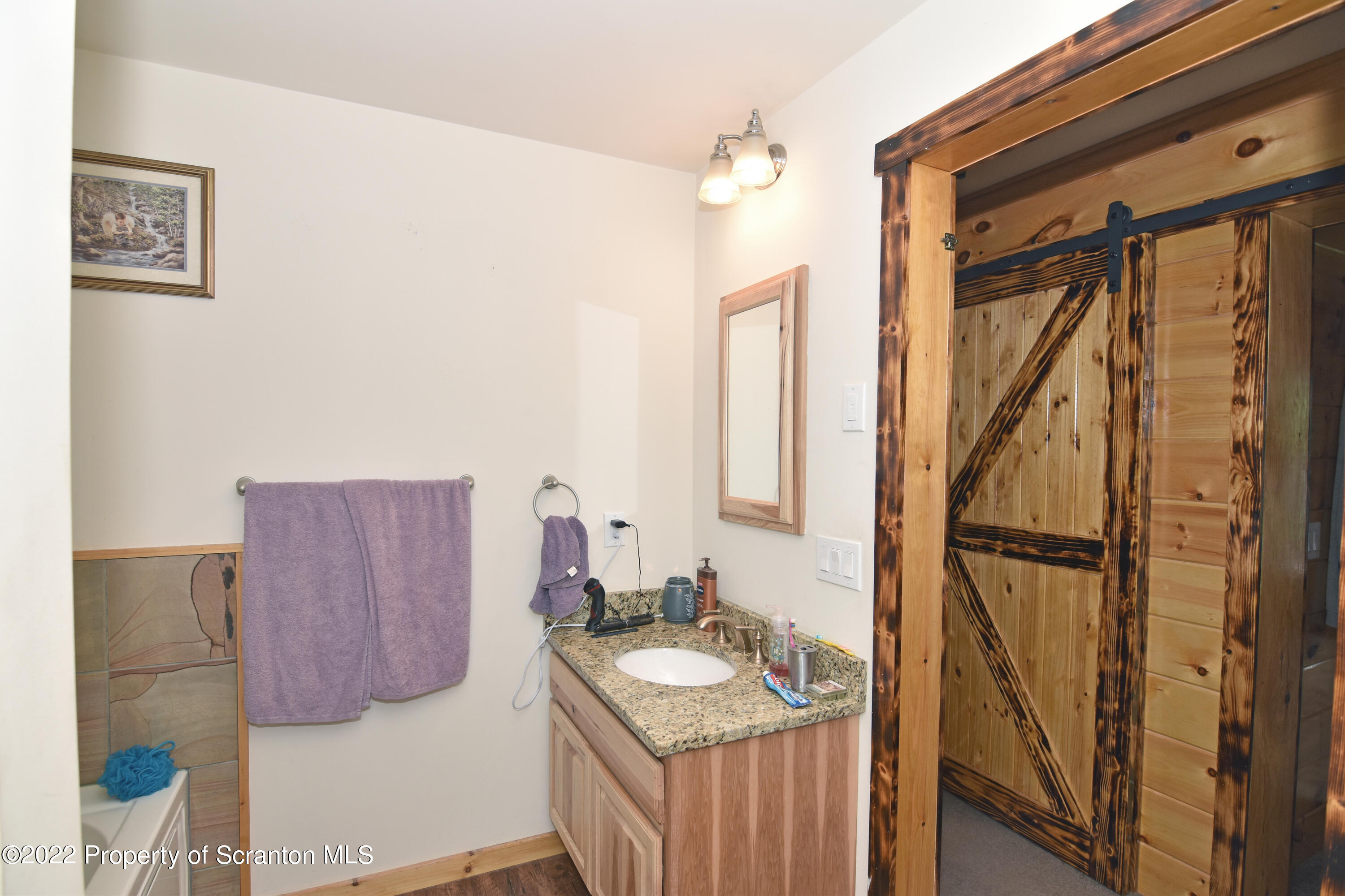 209 Oliver Road Meshoppen, PA 18630 - Photo 14 of 24 a bathroom with a sink a mirror and a shower