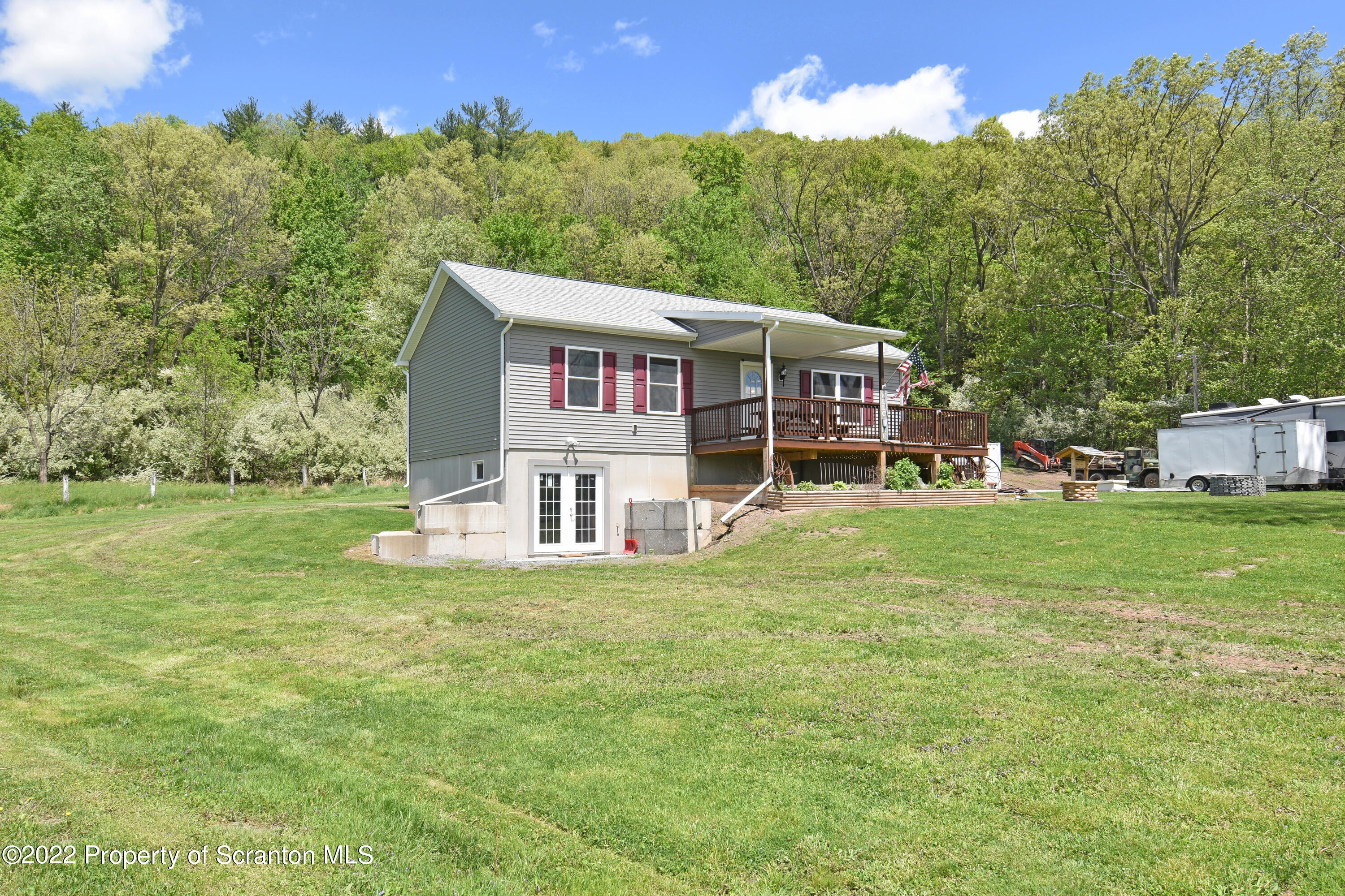 209 Oliver Road Meshoppen, PA 18630 - Photo 2 of 24 a front view of a house with a yard table and chairs