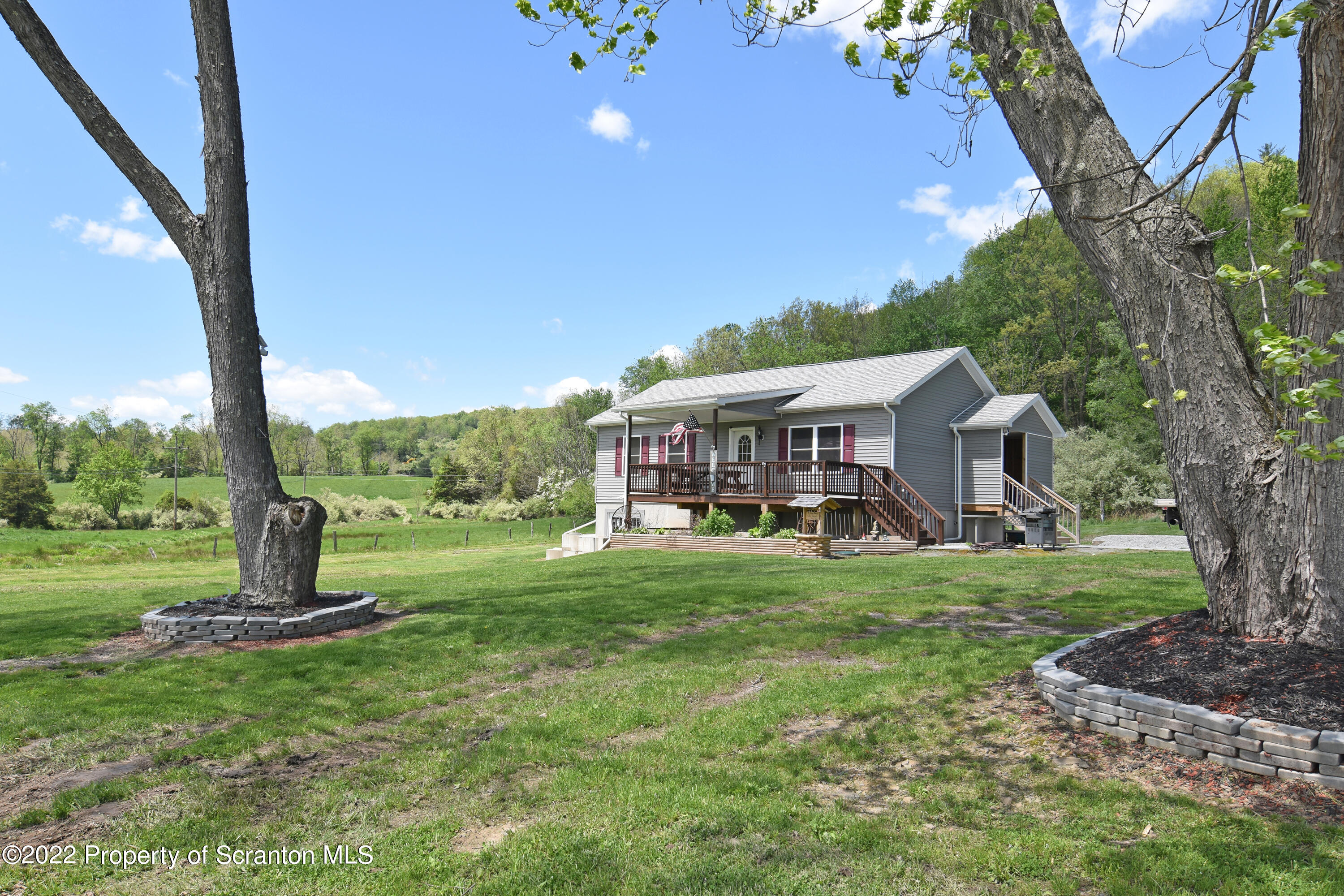 209 Oliver Road Meshoppen, PA 18630 - Photo 3 of 24 a view of a house with backyard and porch