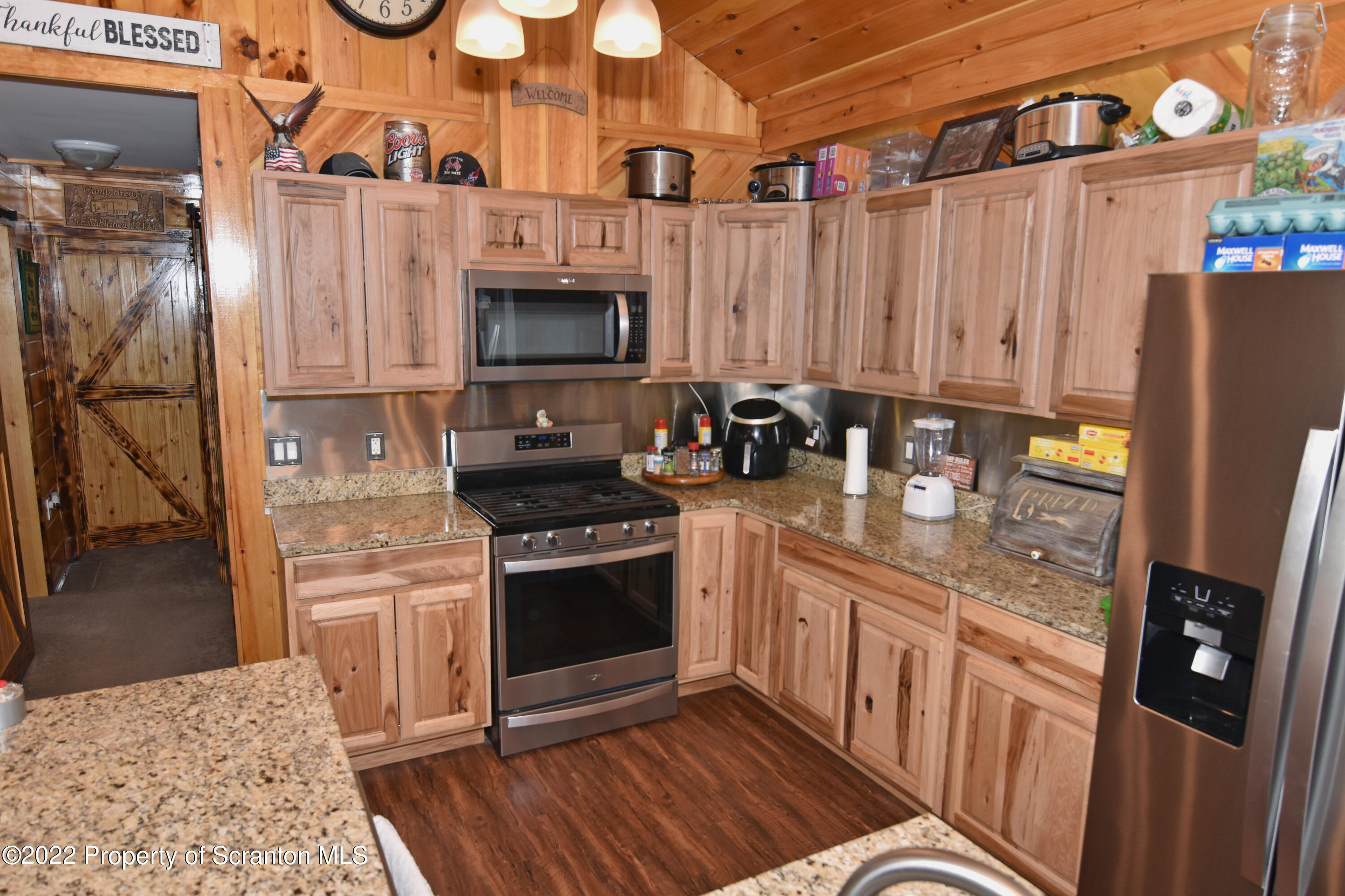 209 Oliver Road Meshoppen, PA 18630 - Photo 8 of 24 a kitchen with stainless steel appliances granite countertop a stove a sink and a refrigerator