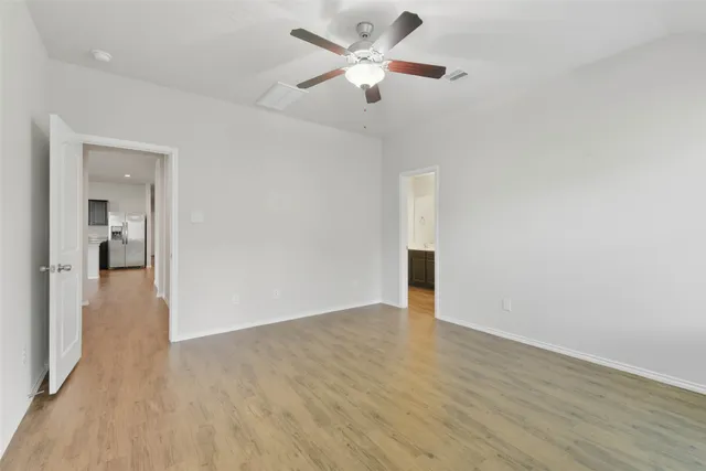 a view of an empty room and wooden floor