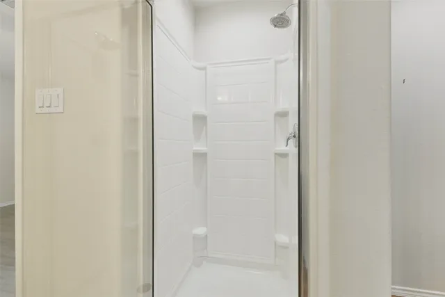 a bathroom with a glass shower door