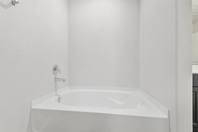 a white bath tub sitting next to a white sink