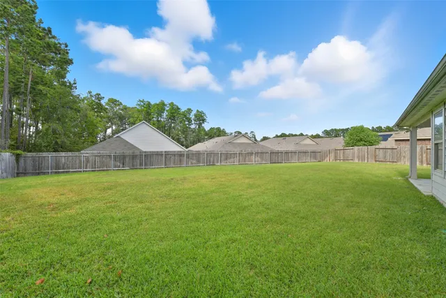 a view of a house with a yard and a fountain