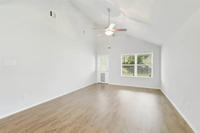 wooden floor in an empty room with a window