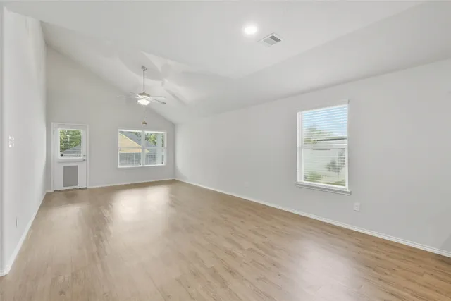 wooden floor in an empty room with a window