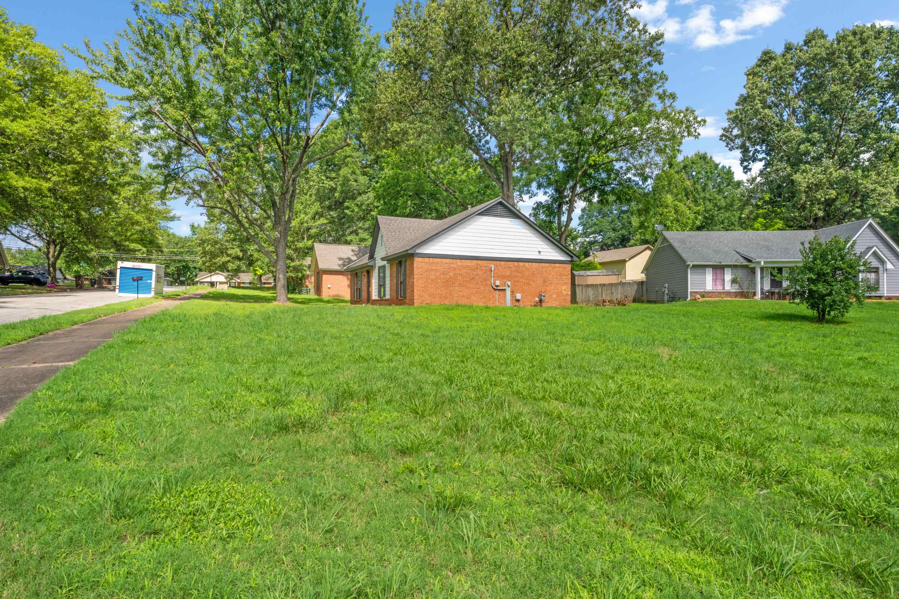 6400 Saginaw Road Memphis, TN 38134 - Photo 25 of 27 Enjoy a wide-open yard with abundant green space, providing flexibility for recreation, play, outdoor gatherings, or landscaping opportunities.