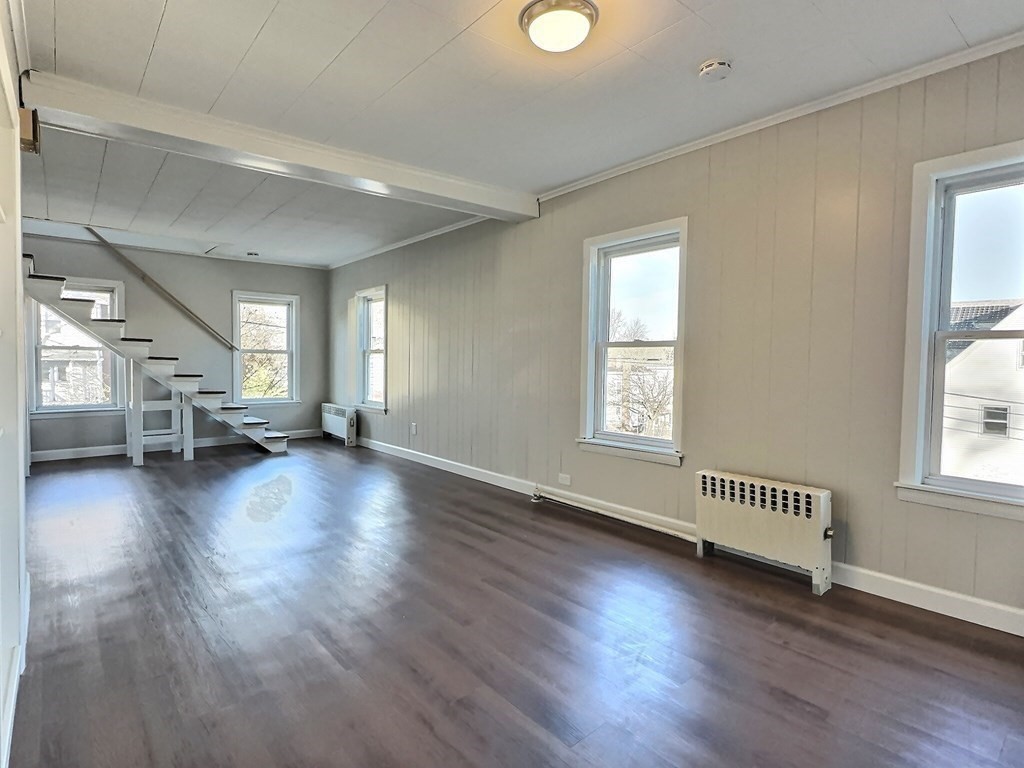 83 Oak Street Springfield, MA 01151 - Photo 3 of 18 an empty room with hard wood floors and windows