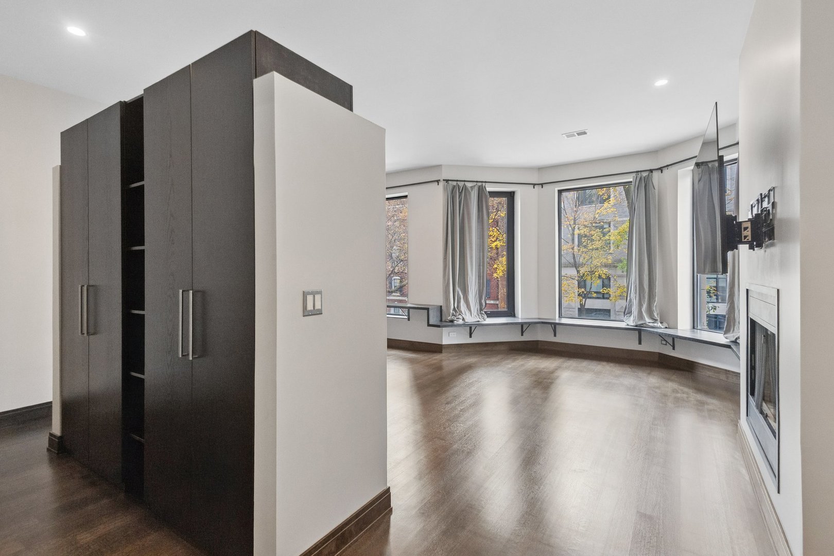 44 East Cedar Street Chicago, IL 60611 - Photo 13 of 35 a view of an empty room with a window and wooden floor