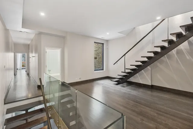 a view of an entryway with wooden floor
