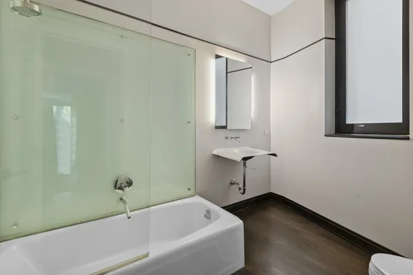 a bathroom with a bathtub and shower