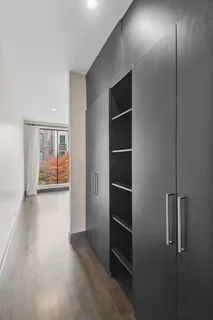 a view of empty room with wooden floor and window