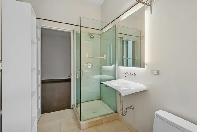 a bathroom with a shower sink and mirror