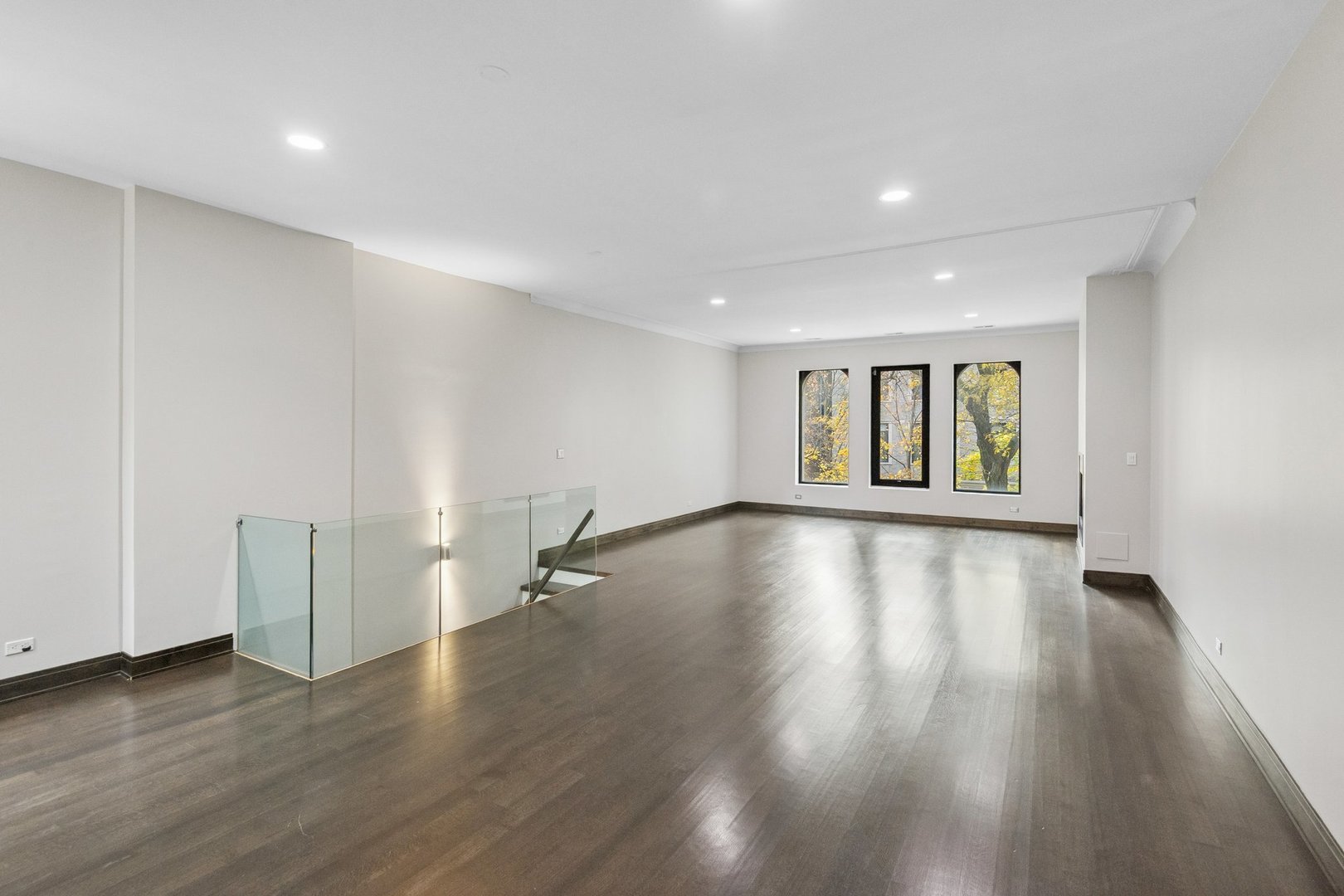 44 East Cedar Street Chicago, IL 60611 - Photo 21 of 35 a view of an empty room with wooden floor and a window