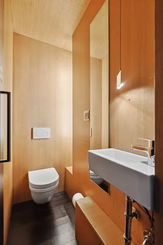 a bathroom with a sink a toilet a mirror and shower