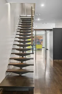a view of entryway and hall with wooden floor