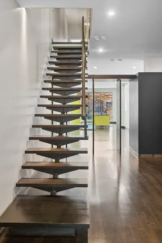 a view of entryway and hall with wooden floor