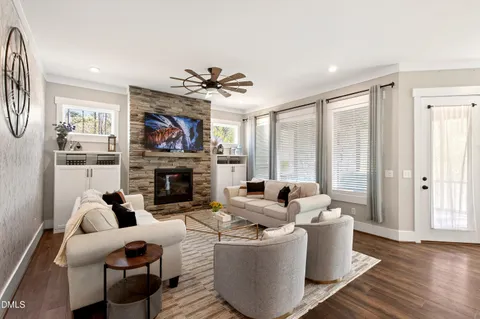 a living room with furniture a fireplace and a large window