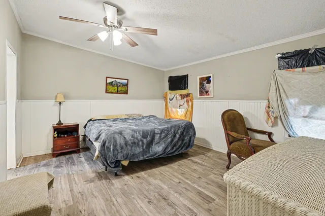 a bedroom with a bed and a chandelier