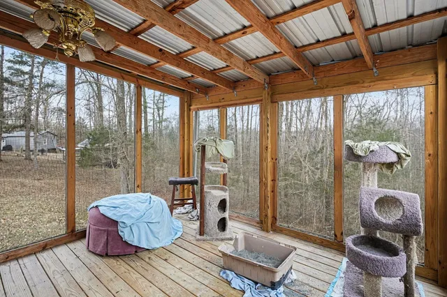 a room with wooden floor table and chairs