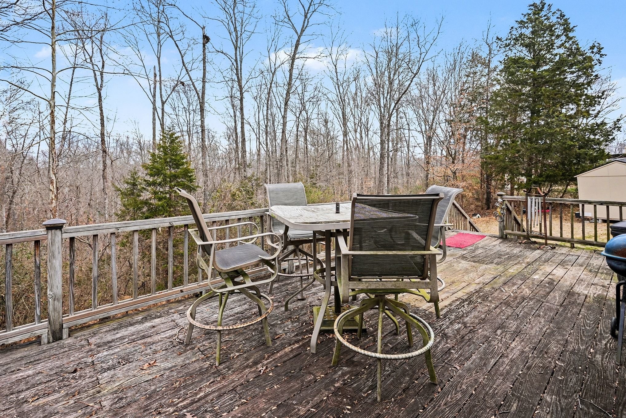 8896 Greer Road Lyles, TN 37098 - Photo 27 of 30 a view of a patio with table and chairs and wooden fence