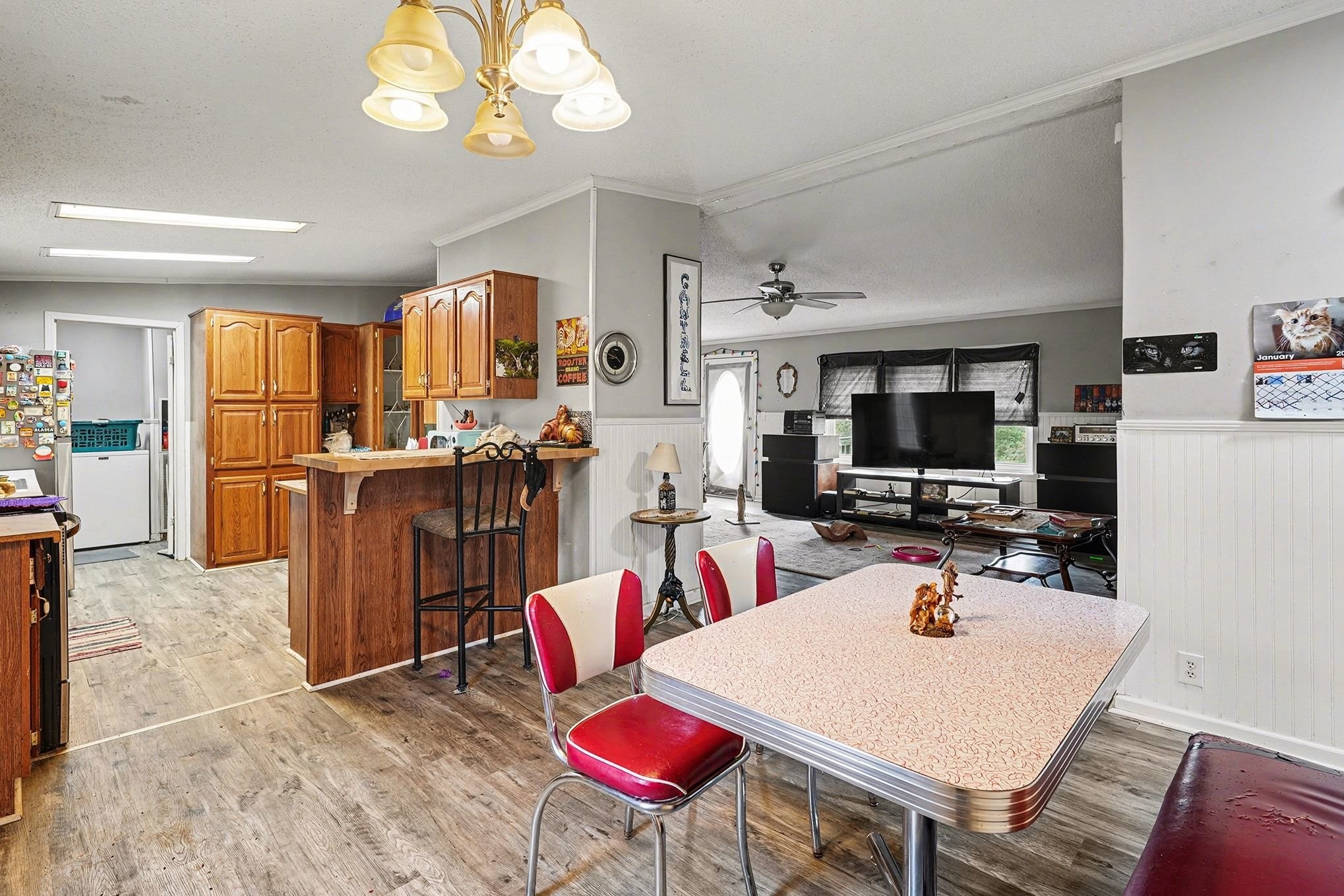 8896 Greer Road Lyles, TN 37098 - Photo 6 of 30 a view of a dining room with furniture and a flat screen tv