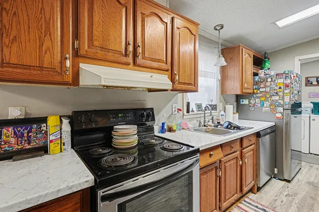 a kitchen with stainless steel appliances granite countertop a stove and a sink