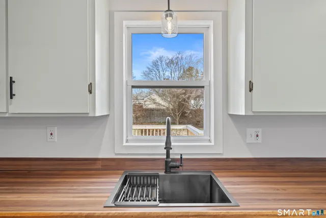 a kitchen with a sink cabinets and window