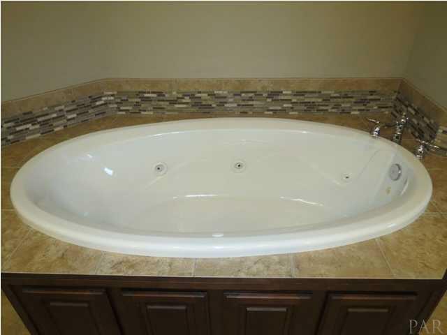 581 West Quintette Road Cantonment, FL 32533 - Photo 13 of 24 Jacuzzi Tub framed in Tile and Wood Panels