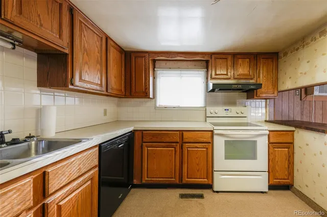 a kitchen with stainless steel appliances granite countertop a sink and cabinets