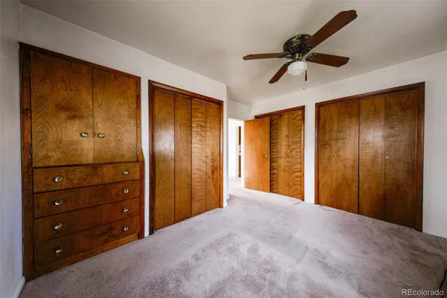 a view of a room with a ceiling fan and a window