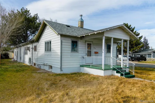 a view of a house with a yard and porch