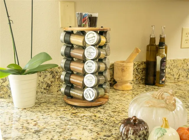 a view of granite countertop cabinets and wooden floor