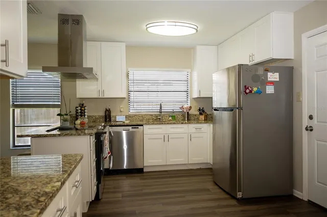 a kitchen with a sink cabinets and window