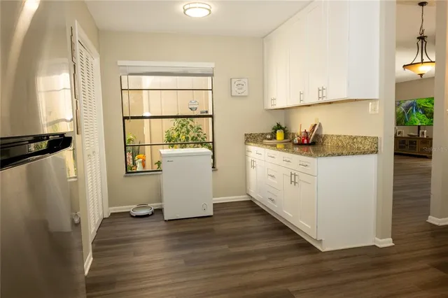 a spacious bedroom with a bed and wooden floor