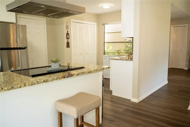 a bedroom with a bed and painting on the wall