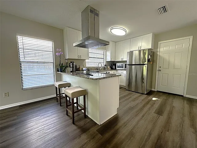a view of an entryway with wooden floor